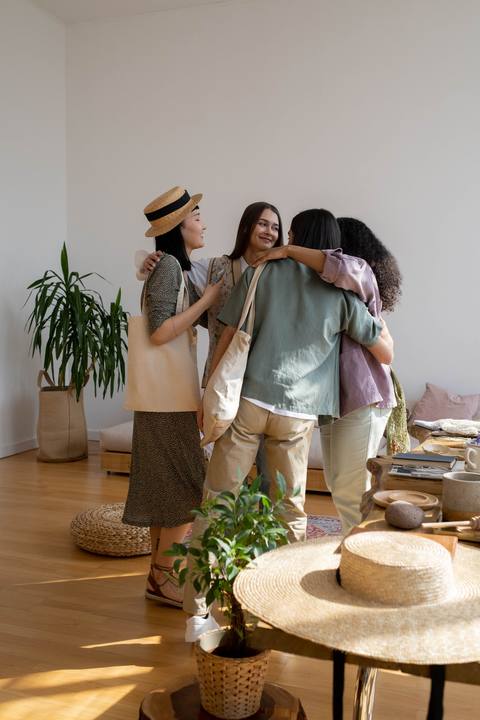 Friends hugging in a bright apartment